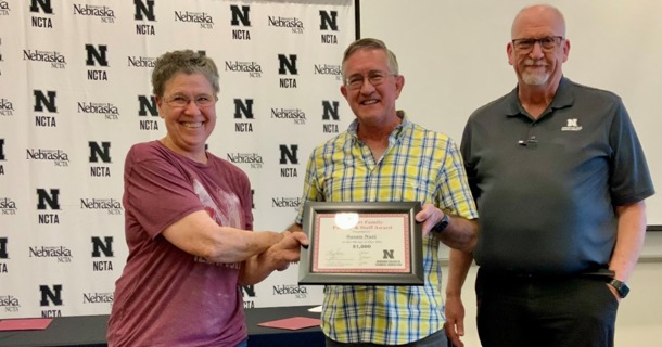 Caption: (L-R) Susan Nutt receives the Stewart Award from Jim Stewart and Dr. Larry Gossen, dean.   